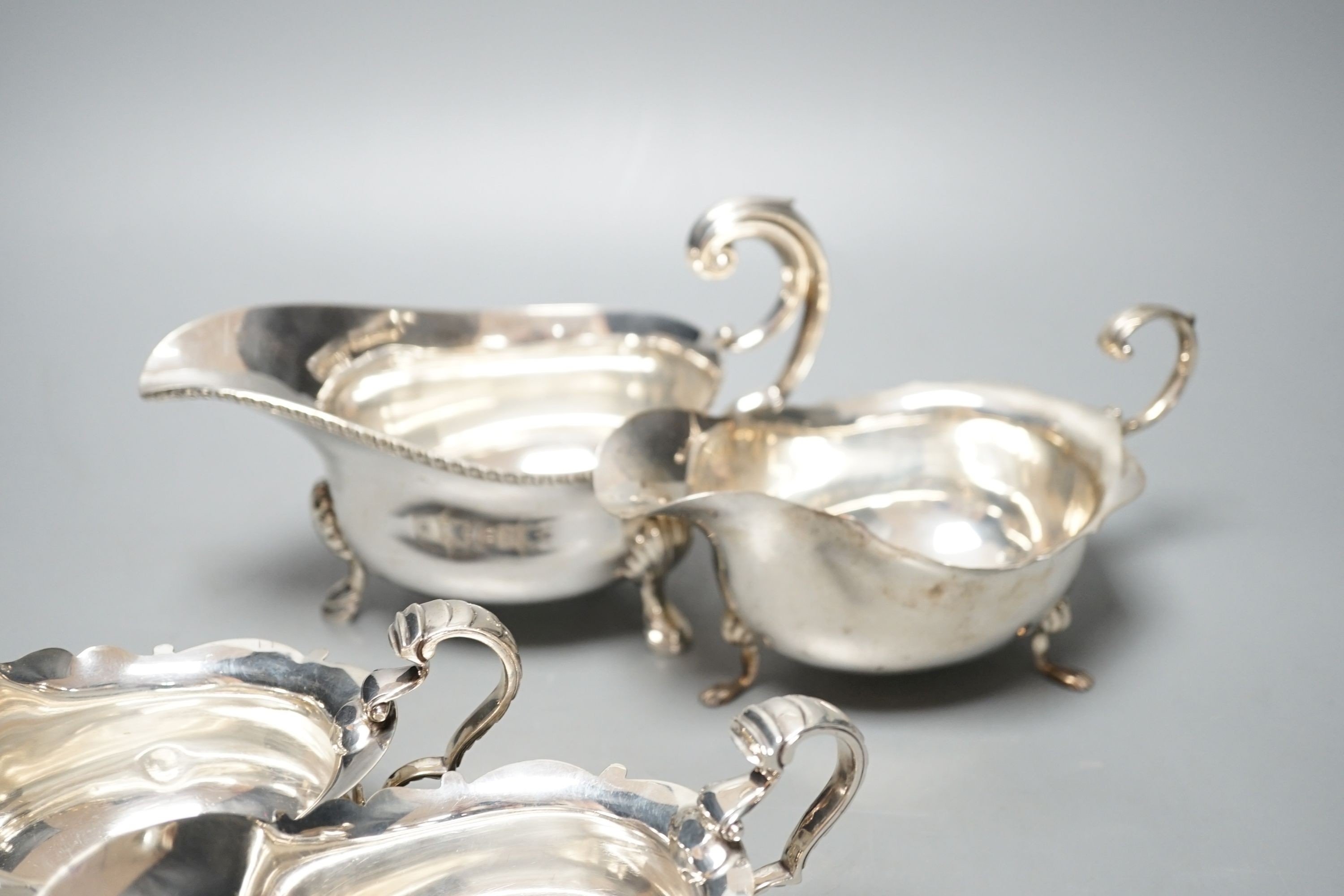 A pair of George V silver sauce boats, London, 1930 and two other larger silver sauceboats, 26oz.